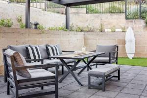 a picnic table and chairs on a patio at Rabbits Break - Beachside Bliss Steps from Yallingup in Yallingup