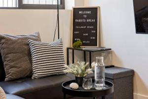 a living room with a couch and a table at Rabbits Break - Beachside Bliss Steps from Yallingup in Yallingup +35 photos