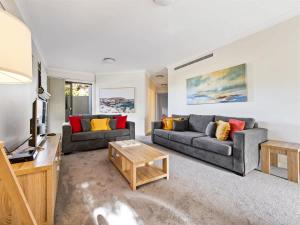 a living room with two couches and a tv at Surfside 1 - An Unforgettable Yallingup Experience in Yallingup