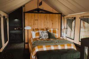 a bedroom with a large bed in a tent at Wandagar Eco Tent - Carnaby in Pemberton