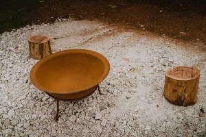 a wooden tub sitting next to two logs at Wandagar Eco Tent - Carnaby in Pemberton +48 photos