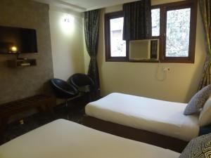 Postel nebo postele na pokoji v ubytování Hotel Sapna