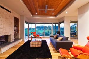 a living room with a couch and a fireplace at Valley Views - Elevated Hilltop Escape near Beaches in Yallingup
