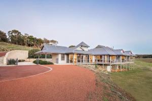 a large house on a hill with a driveway at Valley Views - Elevated Hilltop Escape near Beaches in Yallingup