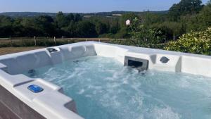 a hot tub in a backyard with water in it at 6 Bed in Hadlow Down oc-g36329 in Hadlow Down