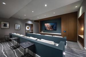 a waiting room with a counter and stools at Hanover Post Oak in Houston +55 photos