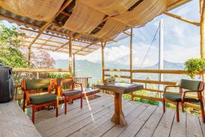 a deck with chairs and a table with a view at Cabaa el Sol Medellin in Titiribí