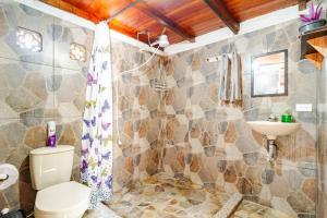 a bathroom with a toilet and a sink at Cabaa el Sol Medellin in Titiribí +131 photos