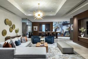 a living room with a couch and a dining room at Hanover Post Oak in Houston