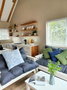 a living room with a couch and a table at Cape St Francis Beach Cottage in Cape St Francis