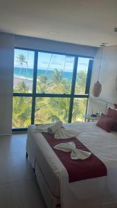a bedroom with a bed with a view of the ocean at Porto Beach Resort - Marulhos in Porto De Galinhas +93 photos