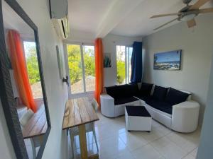 a living room with a couch and a table at Blue Flamingo Kite Beach in Cabarete