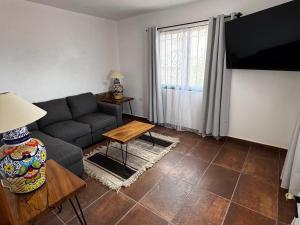 a living room with a couch and a table at Casa Granada in Guanajuato