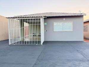 a white door with a gate in front of a house at Casa 20 in Araguaína