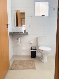 a bathroom with a toilet and a mirror at Casa 20 in Araguaína +16 photos