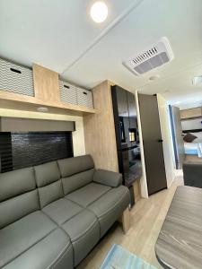 a living room with a couch and a bedroom at Rest Up Retreat-New Lux RV-Private-6Flags-Fire Pit-Hammock-Atlanta in Atlanta