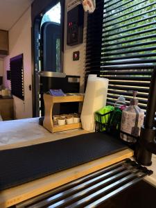 a kitchen with a counter with a table and a window at Rest Up Retreat-New Lux RV-Private-6Flags-Fire Pit-Hammock-Atlanta in Atlanta