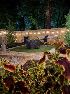 a garden with a ping pong table and lights at Rest Up Retreat-New Lux RV-Private-6Flags-Fire Pit-Hammock-Atlanta in Atlanta