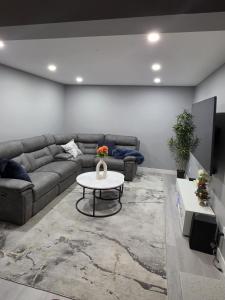 a living room with a couch and a table at Cozy New 2BR Suite Retreat in Calgary
