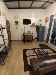 a living room with a couch and a table at บ้านสุขสันต์ พฤกษา45 บางใหญ่ in Ban Nong Kradi