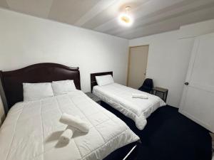 a bedroom with two beds with towels on them at Zenora Suites in San José