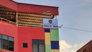 a colorful building with a walk in sign on it at Walk Inn Dipolog City by RedDoorz in Dipolog