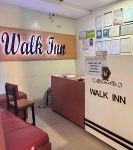 a waiting room with a walk in counter and a refrigerator at Walk Inn Dipolog City by RedDoorz in Dipolog