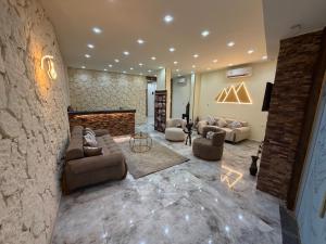 a large living room with couches and a fireplace at Royal Pyramids Hotel in Cairo