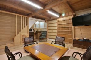 a dining room with a wooden table and chairs at 千年乃宿 in Kubo