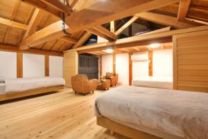 a bedroom with two beds and a fireplace at 千年乃宿 in Kubo