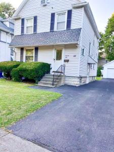 a white house with a driveway in front of it at Room B2 Shared bathroom Kingbed washer dryer in Rochester