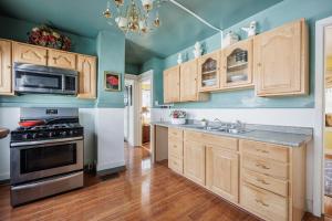 a kitchen with wooden cabinets and a stove at Room B2 Shared bathroom Kingbed washer dryer in Rochester