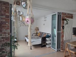 a bedroom with a bed in the middle of a room at Como Green House in Busan