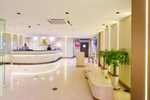 a lobby of a hospital with benches and a bar at Hotel Imperial in Kuala Lumpur