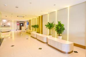a hospital lobby with a row of benches and potted plants at Hotel Imperial in Kuala Lumpur +38 photos