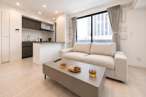 a living room with a couch and a coffee table at Morikoya Hotel in Tokyo