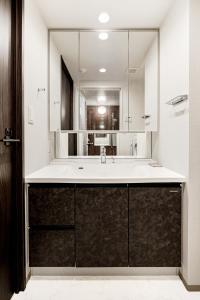 a bathroom with a sink and a large mirror at Morikoya Hotel in Tokyo +56 photos