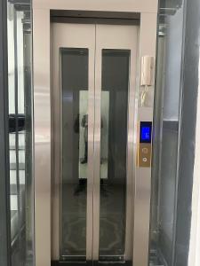 an elevator with three doors in a building at Flower Apartment in Buôn Enao +10 photos