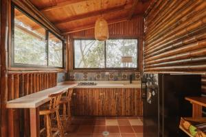a kitchen with a counter and a refrigerator in a room at Mantoverde in Dosquebradas +70 photos