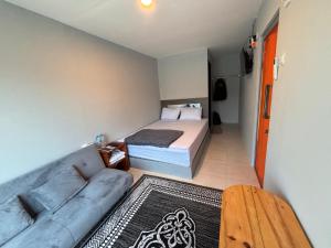 a small room with a bed and a couch at Contana Paris in Girijati +36 photos