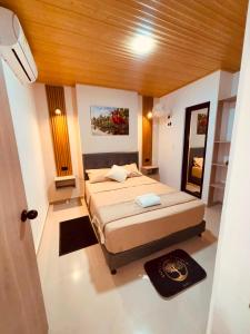 a bedroom with a bed and a wooden ceiling at Hotel del Parque Arauca in Arauca +15 photos
