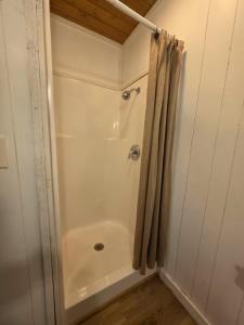 a white shower with a shower curtain in a bathroom at River Run Maggie's house in Kerrville