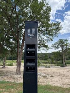 a black machine sitting in the middle of a field at River Run Maggie's house in Kerrville +6 photos