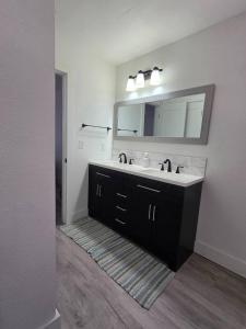 a bathroom with a sink and a mirror at River Run Retreat in Kerrville