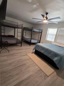 a bedroom with two bunk beds and a ceiling fan at River Run Retreat in Kerrville