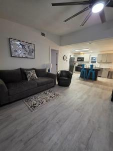 a living room with a couch and a dining room at River Run Retreat in Kerrville