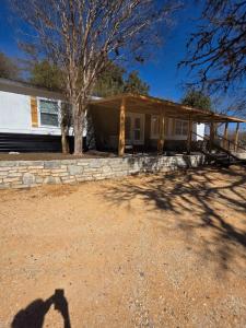 a shadow of a person taking a picture of a house at River Run Retreat in Kerrville