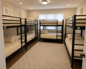 a room with four bunk beds with a window at David s Guesthouse in Hallandale Beach