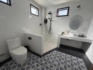 a white bathroom with a toilet and a sink at Loy Manee House in Phra Nakhon Si Ayutthaya +56 photos