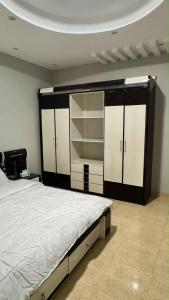 a bedroom with a large bed and some closets at بيّت الضيافة in Al Baha